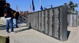 Visitors used time before the Tuesday's ceremony to look up friends and relatives at the wall set aside for veterans.